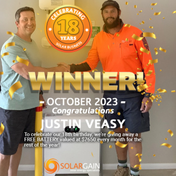 Justin Veasy receiving a solar battery prize from Solargain